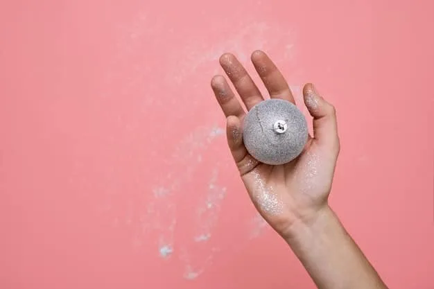 A close-up of a hand gently scrubbing a diamond ring with a soft brush over a small bowl of soapy water, illustrating a careful home cleaning process.