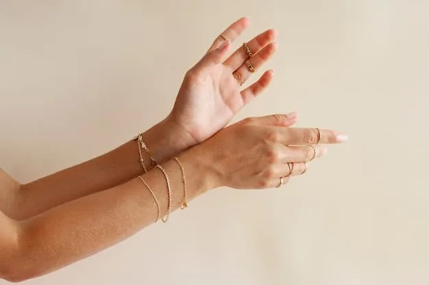 A close-up of a hand wearing layered, delicate gold-plated rings and a minimalist bracelet, showcasing affordable yet elegant jewelry.