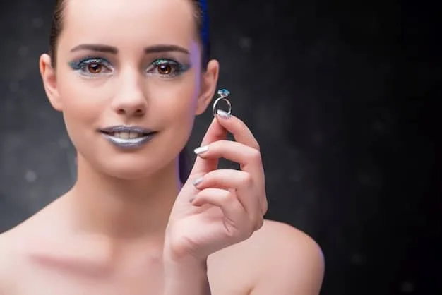 A close-up of a person with cool undertones wearing elegant silver earrings with blue aquamarine gemstones, showcasing the harmonious color palette.