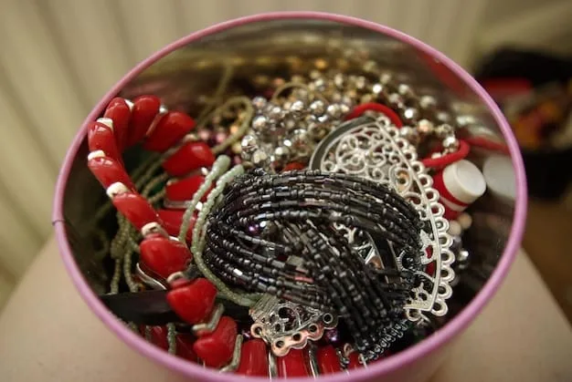 A neatly organized jewelry box, with individual compartments holding various repurposed necklaces and earrings, highlighting proper storage.