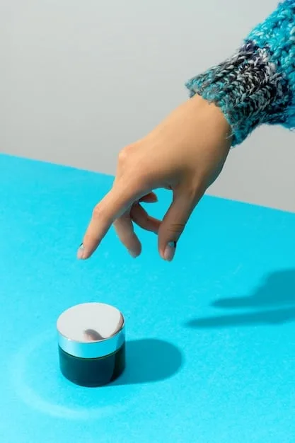 A person's hand carefully inspecting a small expiration icon on the bottom of a foundation bottle, with other makeup items blurred in the background.