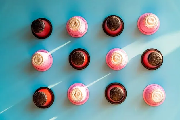 A close-up flat lay of various lipstick bullet types and liquid lipsticks, alongside lip liners and a small pot of lip scrub, all neatly arranged.