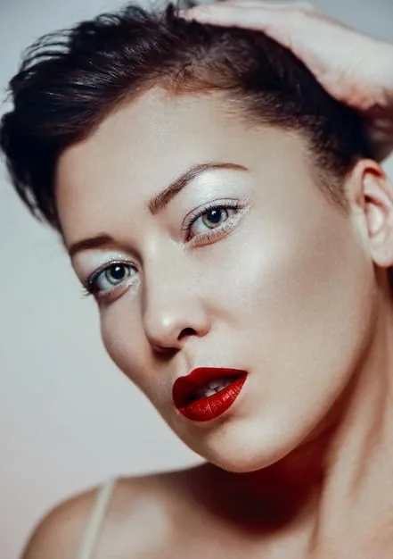 A close-up of a model's face with minimalistic makeup, focusing on clear, glowing skin, subtle cheek color, and a soft, blurred lip, illustrating the