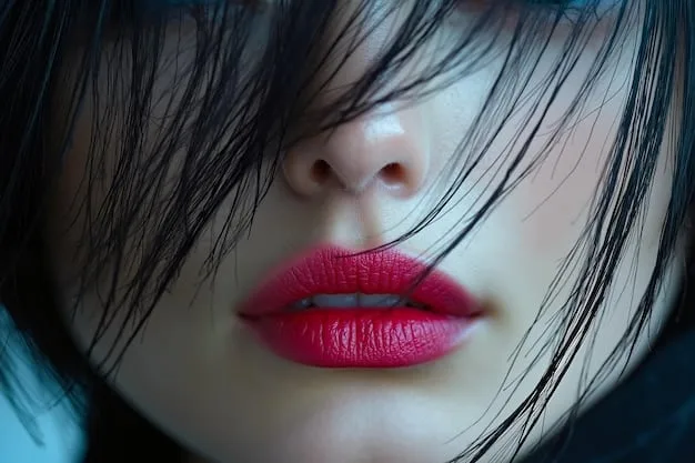 A close-up of a model's lips featuring a soft, blurred red lip stain with a subtle gloss finish, embodying the