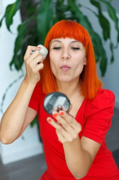 A beauty blogger demonstrating in a close-up shot, gently patting a sheer layer of liquid peach corrector under her eye with her ring finger, blending it seamlessly into her skin.