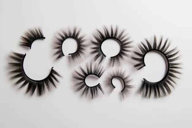 Varieties of false eyelashes laid out on a clean white surface, showcasing different styles for various eye shapes.