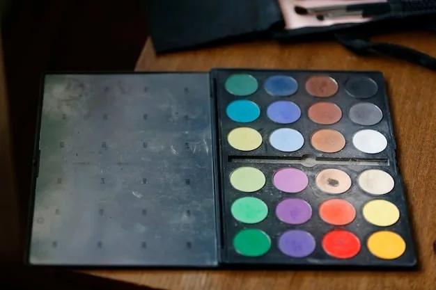 A vibrant eyeshadow palette display with various matte, satin, and shimmer shades in cool and warm tones, ready for application.