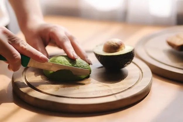 A person's hand scooping a DIY face mask made from avocado from a small bamboo bowl, emphasizing the natural ingredients and the hands-on approach.