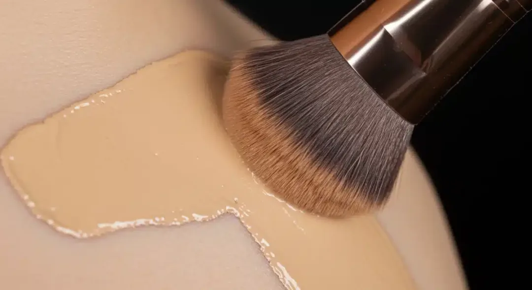 Professional foundation brush blending liquid makeup smoothly.