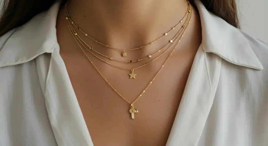 Delicate gold layered necklaces creating a harmonious look