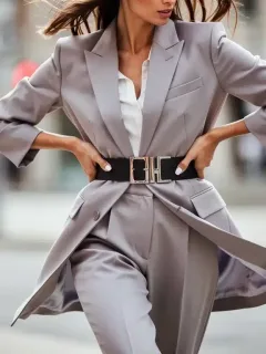 Woman transforming outfit with a stylish belt, showcasing 2026 fashion trends