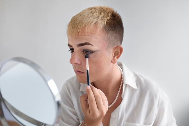 Close-up of a person applying an eyeshadow primer to their eyelid, showing a smooth, even application.