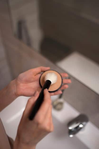 A detailed shot of an individual carefully cleaning a makeup brush with gentle soap and water.