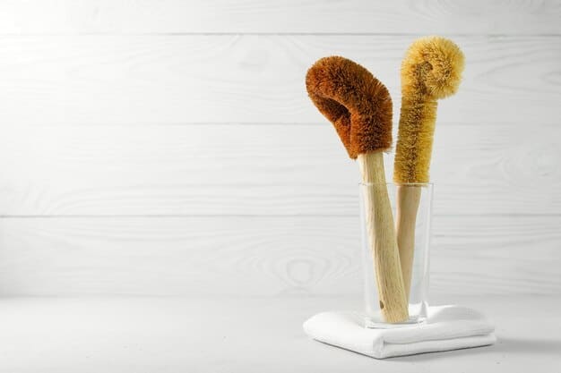 A set of various makeup brushes laid flat on a clean, white towel, drying after being washed, showcasing proper drying technique.