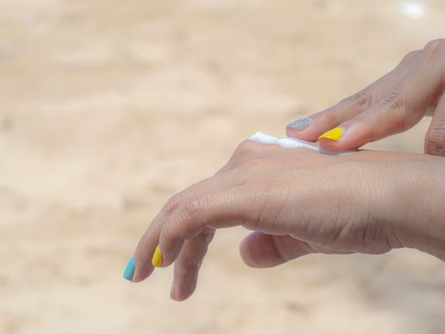 A person's hand applying a generous amount of sunscreen to their arm, with blurred beach background. Focus on the thick, even layer of sunscreen, implying proper application.