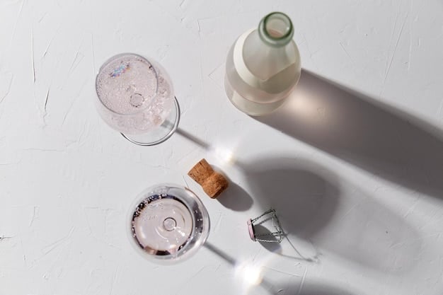 A minimalist flat lay of various skincare products, including a hyaluronic acid serum bottle, a moisturizer jar, and a facial mist, surrounded by fresh water droplets, representing a complete hydration routine.
