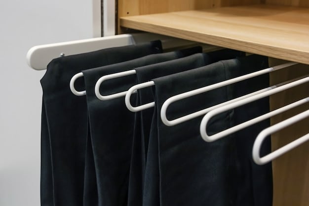 A neatly organized capsule wardrobe with classic white shirts, dark wash jeans, a black blazer, and neutral accessories hanging in an open closet, emphasizing timeless pieces.