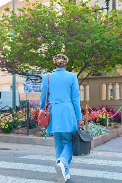 A person wearing a bright, confidence-boosting outfit (e.g., a vibrant blue blazer) confidently walks down a city street, conveying professionalism and individuality.