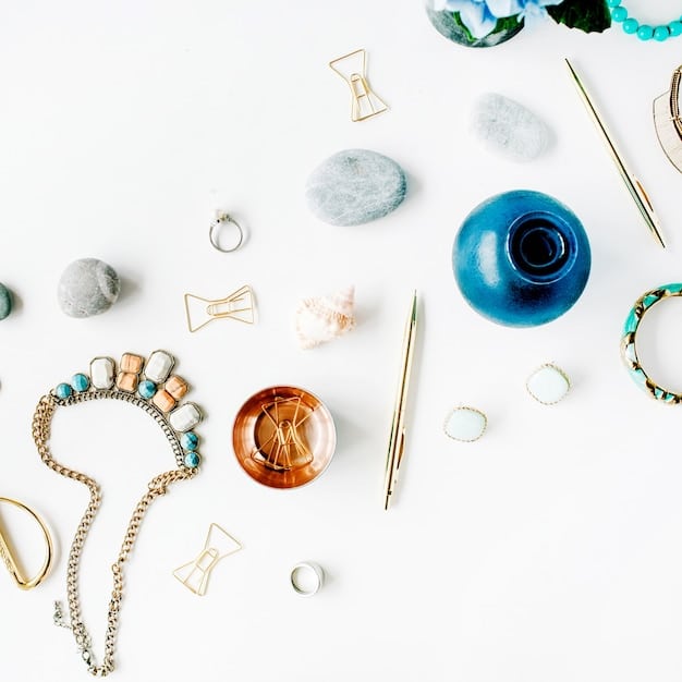 A flat lay of various accessories, including necklaces of different lengths, stacked bracelets, and rings, arranged artistically on a neutral background.