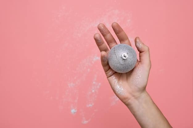 A close-up of a hand gently scrubbing a diamond ring with a soft brush over a small bowl of soapy water, illustrating a careful home cleaning process.