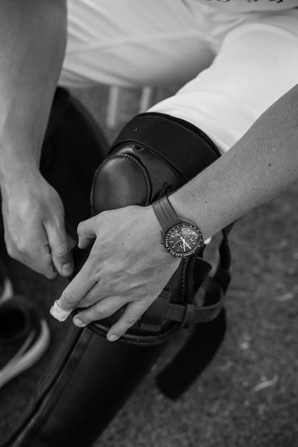 A close-up of a well-groomed hand wearing a classic, simple wristwatch, symbolizing punctuality and attention to detail in a professional setting.