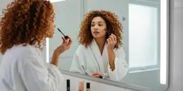 Woman applying quick minimalist makeup in a modern bathroom